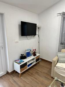 a living room with a tv on a wall at Lora in Skradin