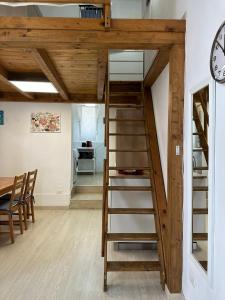 a loft bed with a ladder in a room at Cami s holidays home mare in Catania