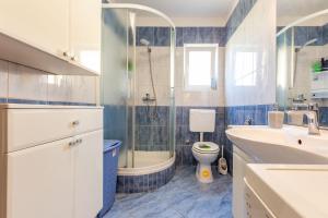a bathroom with a shower and a toilet and a sink at Lanterna Puntamika apt. near beach in Zadar