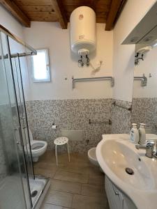 a bathroom with a sink and a toilet and a shower at Cami s holidays home mare in Catania