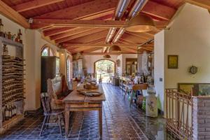 a living room with a wooden table and chairs at Resort La Ghiaia in Sarzana