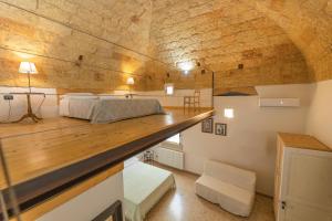 a large room with a bed and a wooden counter at B&B Casa Probo in Tricase