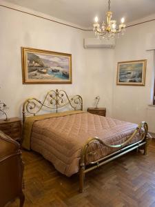 a bedroom with a bed and a chandelier at Da Gianni al Mare in Lavagna