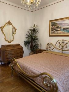 Schlafzimmer mit einem Bett und einem Wandspiegel in der Unterkunft Da Gianni al Mare in Lavagna