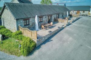 an aerial view of a stone house with a patio at Ocean View Cottage 2 - 2 Bed Cottage - Llanrhidian in Llanrhidian