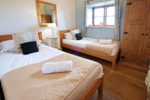 sypialnia z 2 łóżkami i oknem w obiekcie Ocean View Cottage 2 - 2 Bed Cottage - Llanrhidian w mieście Llanrhidian