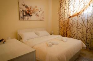 a bedroom with two beds with towels on them at Villa Apartments S&F City Centre in Tirana