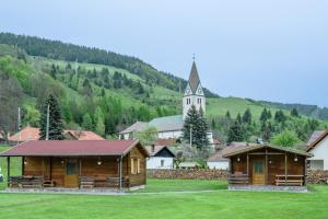 un pequeño pueblo con una iglesia en el fondo en Biotour Camping & Restaurant en Ghimeş