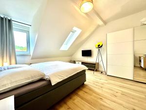 1 dormitorio en el ático con 1 cama y TV en Zentral gelegene DG-Wohnung mit 4 Schlafzimmern, en Eisenach