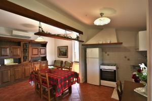 a kitchen with a table and a kitchen with a refrigerator at Mamaamelia in Levanto +23 photos