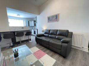 a living room with a couch and a table at Jacksons Modern Retreat Close to Tynemouth in Tynemouth