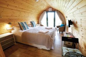 a bedroom with a bed in a wooden room at Ocean View 6 - 1 Bed Large Bridal - Llanrhidian in Llanrhidian