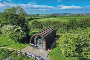 a small house in the middle of a field at Ocean View 6 - 1 Bed Large Bridal - Llanrhidian in Llanrhidian