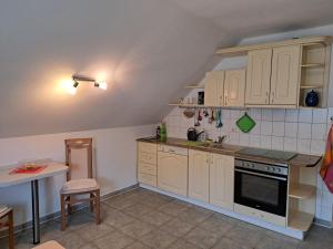 a kitchen with white cabinets and a sink and a table at FWO Marlies 1a in Monplaisir