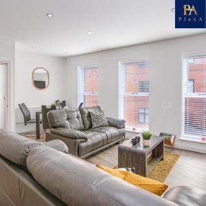 a living room with a couch and a table at Pluxa The Hideaway - Fully private serviced apartment & parking in Birmingham