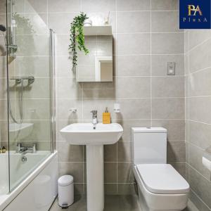 a bathroom with a sink and a toilet and a shower at Pluxa The Hideaway - Fully private serviced apartment & parking in Birmingham