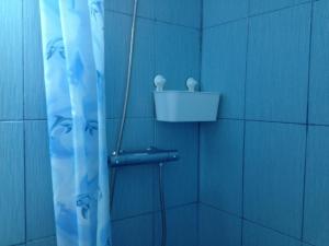 a bathroom with a shower with a blue wall at Casa Mario in 2 Mai +39 photos