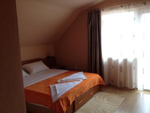a bedroom with a bed and a large window at Casa Mario in 2 Mai
