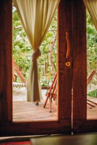 an open door to a deck with a curtain at Ikal Tulum Hotel in Tulum