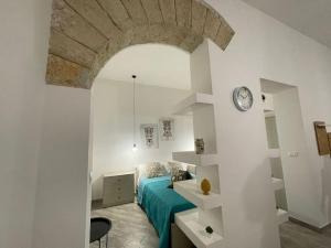 a bedroom with a bed and a clock on a wall at Sea sicily home in Santa Flavia