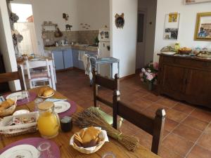 a kitchen with a table with food on it at B&B Il Gatto Pescatore in Stintino