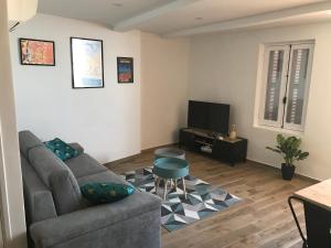 a living room with a couch and a table at Duplex 6 Pers - Panoramic Sea View - Old City - 2 mn Beach in Menton