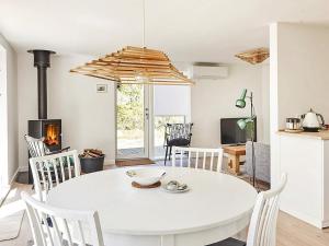 a white dining room with a white table and chairs at Holiday home Holbæk III in Holbæk