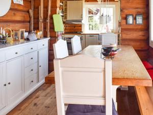 a kitchen with a wooden table and white cabinets at 6 person holiday home in HURDAL-By Traum in Hurdal