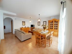 a living room with a table and a couch at Casas de Benaojan 15 in Benaoján