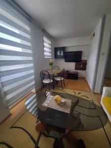 a living room with a table and a dining room at Apartman Benat in Stolac