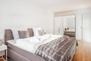 a bedroom with a large bed and a mirror at Cocoon am Schloß in Lochau
