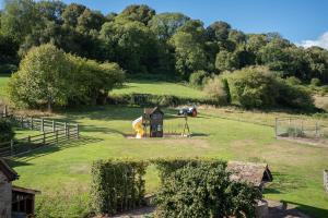 a park with a playground and a play structure at Meadow Byre in Little Dean