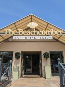 a building with a sign that reads the beachedeat drink library at Shorefield Country Park Self-Catering Holiday Home in Lymington