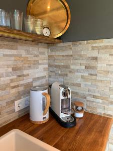 a kitchen counter with a toaster on a wooden counter top at Idyllische Fewo Belling Spa - eigene Sauna und E-Ladesäule in Dresden