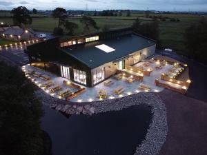 an aerial view of a large building with lights at Luxury Lakeside Lodge with HTub Beautiful Views in Annan