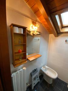 a bathroom with a sink and a toilet in it at Lory apartment in Bardolino +7 photos