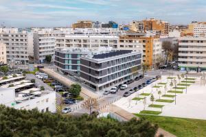 a city with cars parked in a parking lot at Four Points by Sheraton Matosinhos in Matosinhos