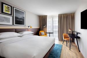 a hotel room with a bed and a desk at Four Points by Sheraton Matosinhos in Matosinhos