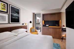 a hotel room with a bed and a tv at Four Points by Sheraton Matosinhos in Matosinhos