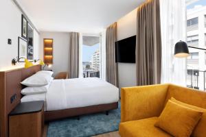 a hotel room with a bed and a couch at Four Points by Sheraton Matosinhos in Matosinhos