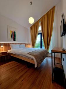 a bedroom with a large bed and a window at RA House in Braşov