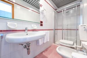 a bathroom with a sink and a toilet at Hotel Aurora in Desenzano del Garda