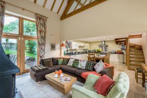 a living room with a couch and a table at Orchard Barn in Little Dean