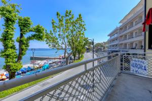 a balcony of a hotel with a view of the beach at Hotel Aurora in Desenzano del Garda