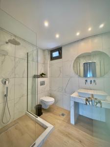a bathroom with a shower and a sink and a toilet at Life's Moments in Limenaria