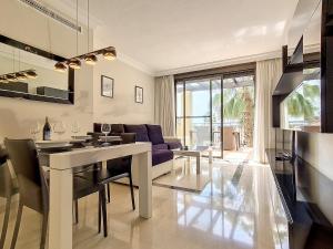 a kitchen and living room with a table and a couch at Roda Golf London Apartment - 9209 in San Javier