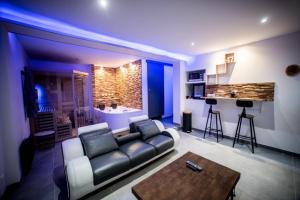 a living room with a couch and a table at Wood 47 spa in Précy-sur-Oise +5 photos