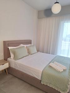 Postel nebo postele na pokoji v ubytování Dionysia Suites