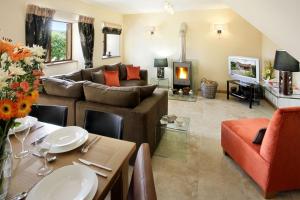 a living room with a couch and a table at Stables in Little Dean