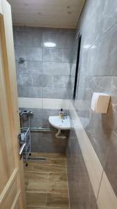 een badkamer met een witte wastafel en een douche bij Weekend house Lokve - Modern in Berane